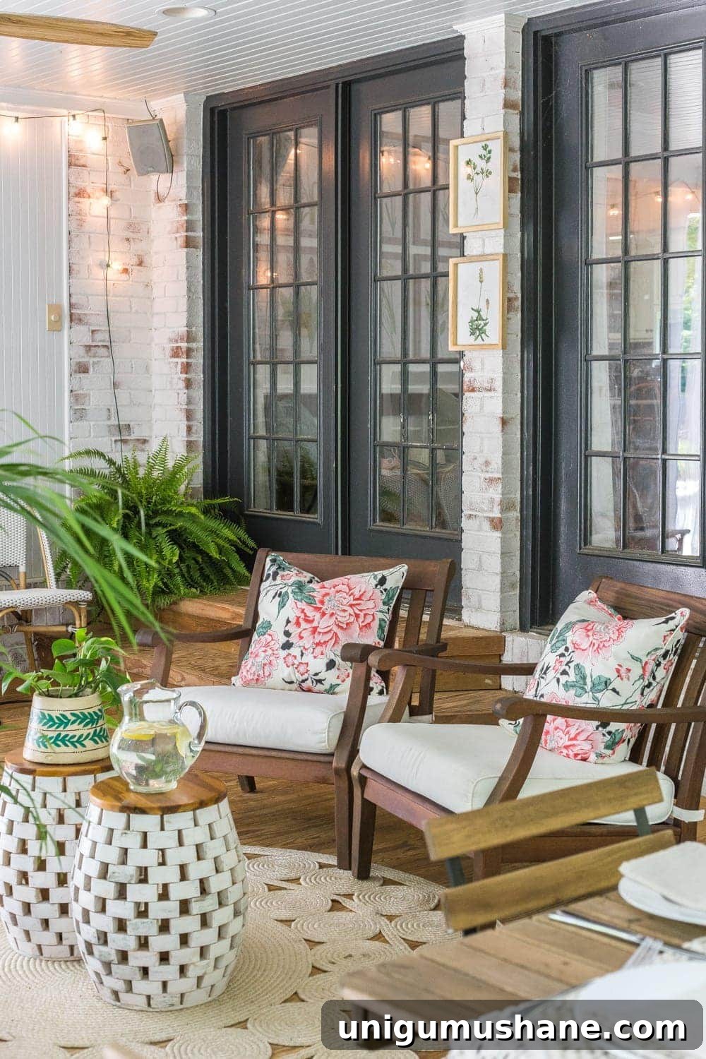Boho Summer Back Porch Makeover Ideas 9 A tropical boho back porch decorated for summer with breezy, functional style from Flower Home and string lights for evening ambience.