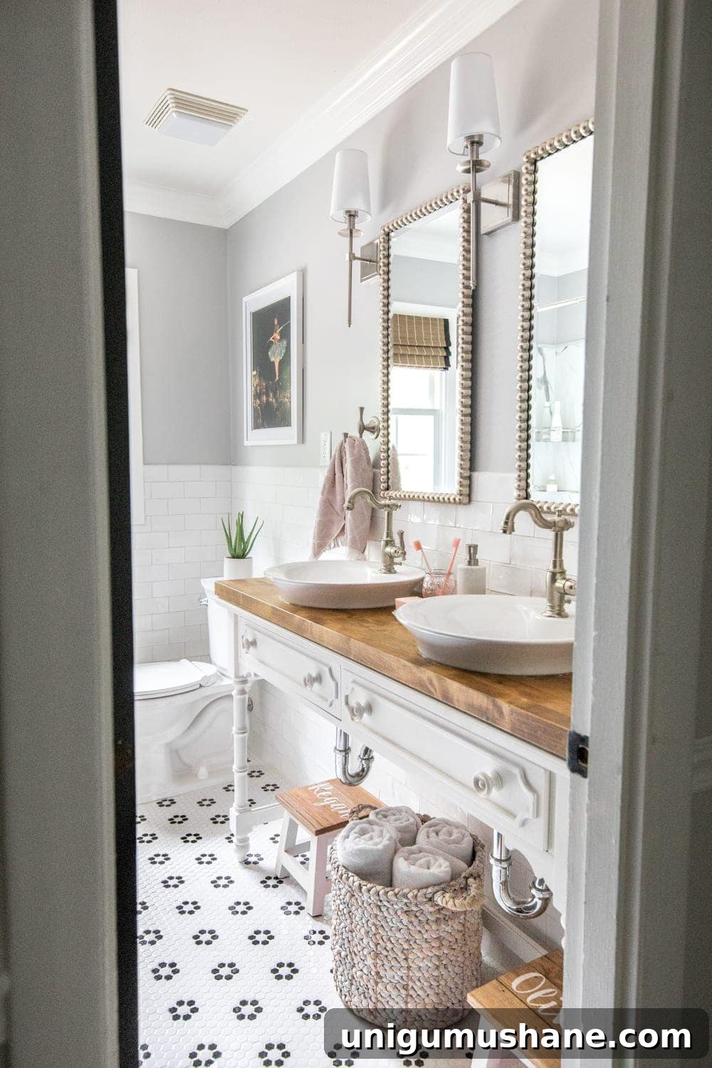 Whimsical, classic kids bathroom makeover | open vanity table with step stools and vessel sinks