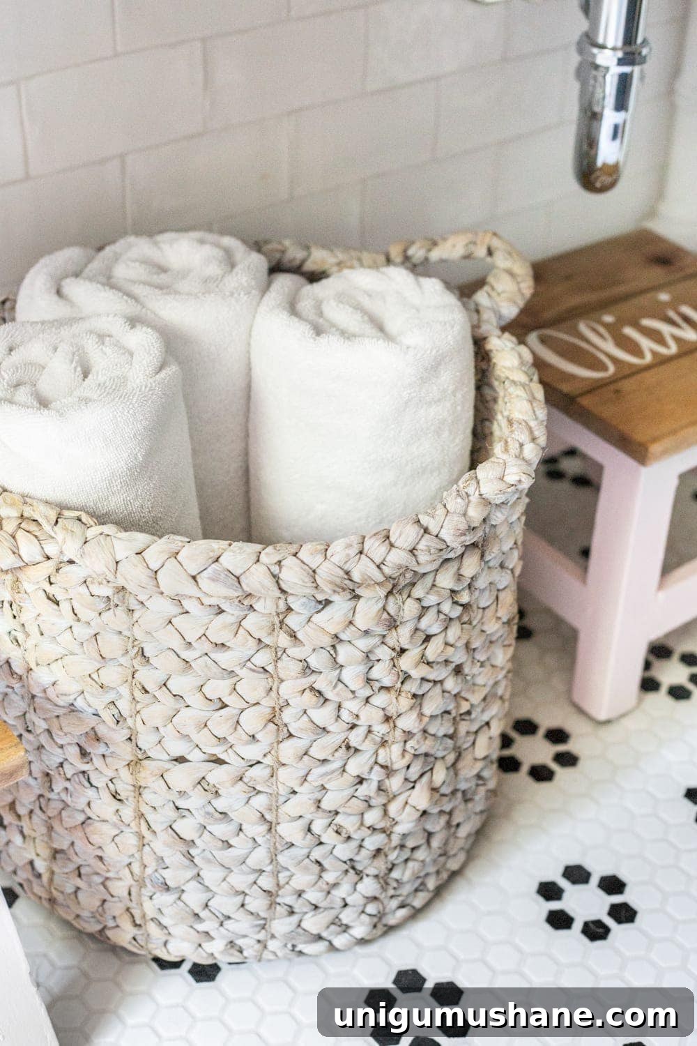Girls' Bathroom Decor Details & Sources | basket of towels underneath an open vanity table