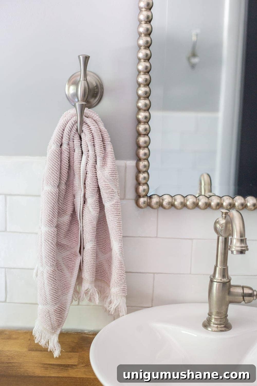 Girls' Bathroom Decor Details & Sources | hand towel hook, beaded mirror, vessel sink on butcher block countertop