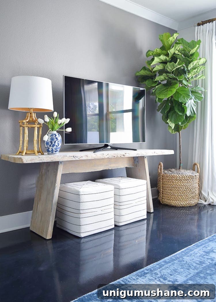 Add visual height beside a TV to distract from it. Add a floor lamp or a tall plant and suddenly that TV doesn't stick out quite so much. 