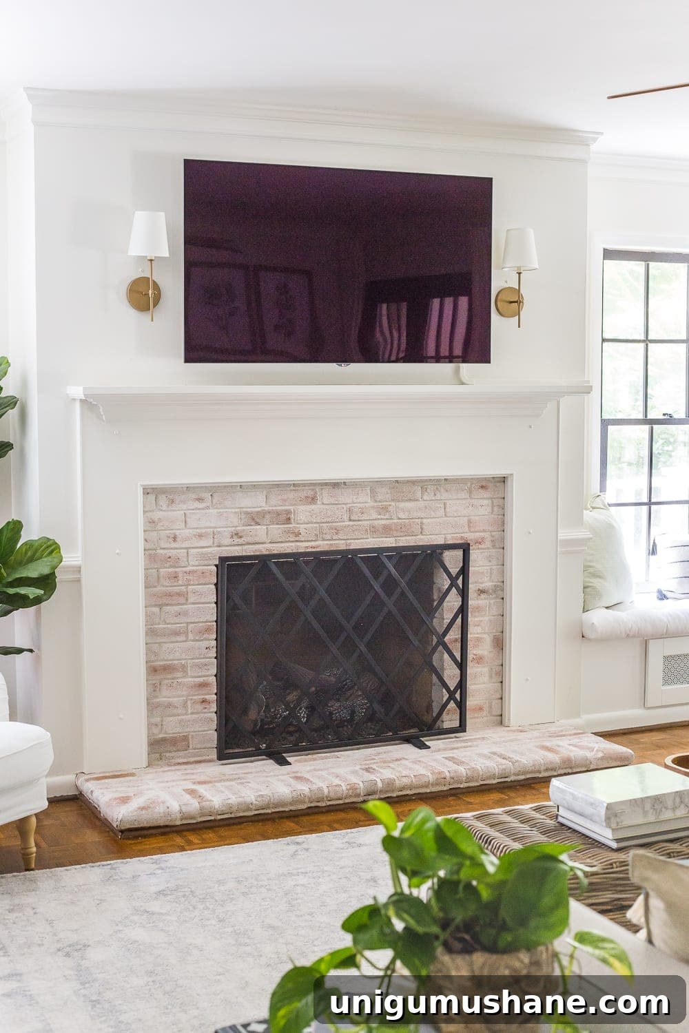 Keep your mantel simple and minimalist with just a pair of sconces on either side of your TV.