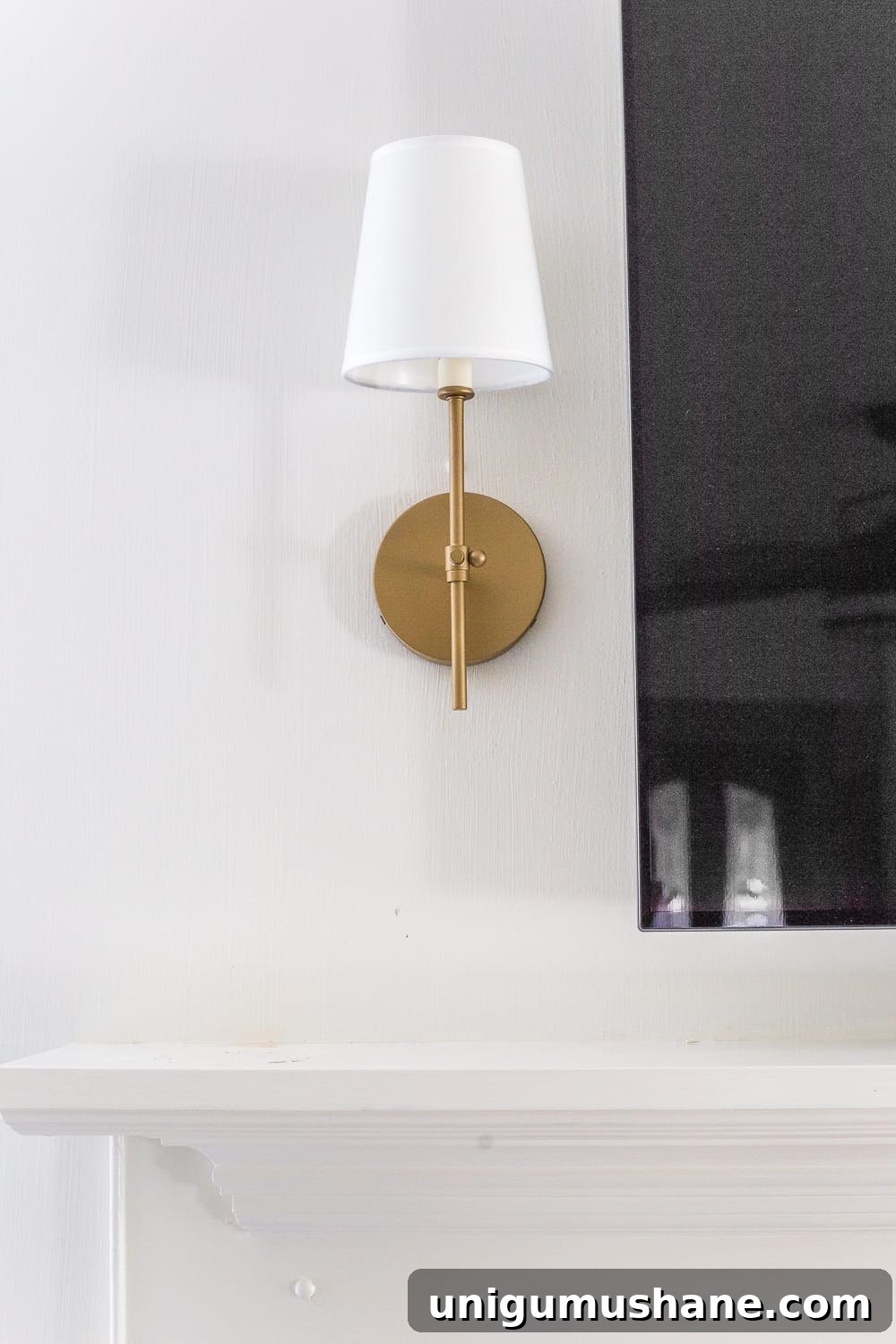 Keep your mantel simple with just a pair of sconces on either side of your TV.