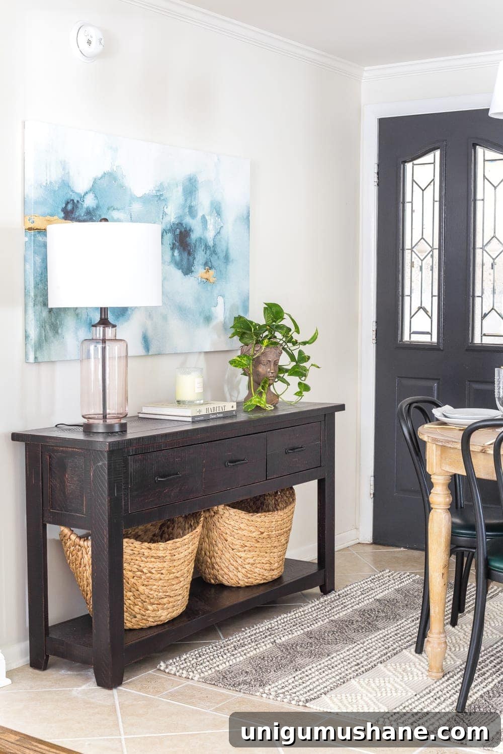 Small Breakfast Nook Makeover Reveal 6 A console table beside an entry door in a breakfast nook to maximize on storage without the use of a mudroom.