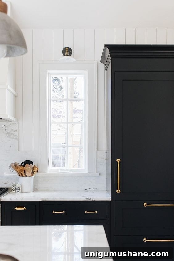 Black Paint Ideas for Dramatic Home Interiors 7 Elegant black accent wall with art and warm textures