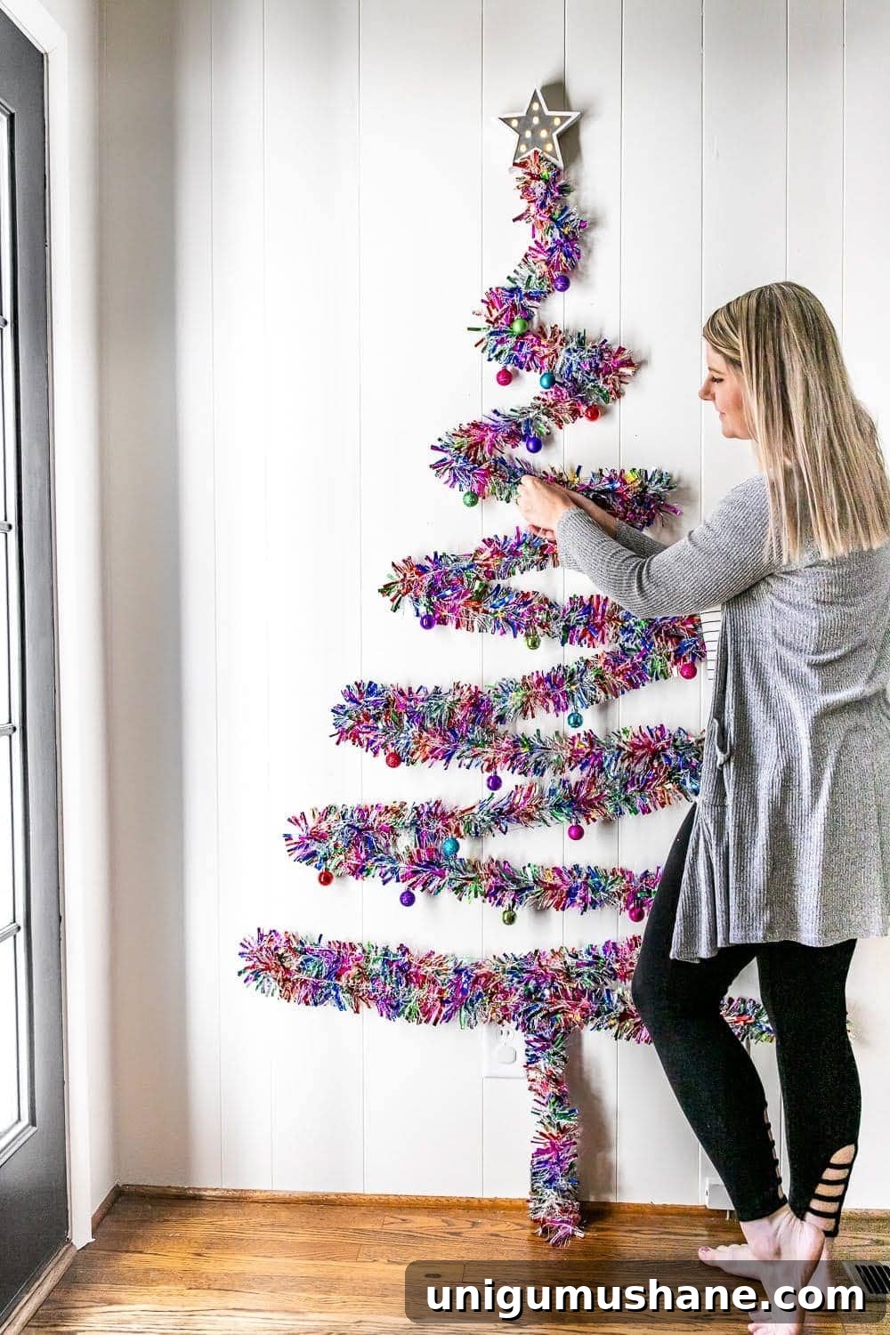 Adding ornaments to a wall Christmas tree