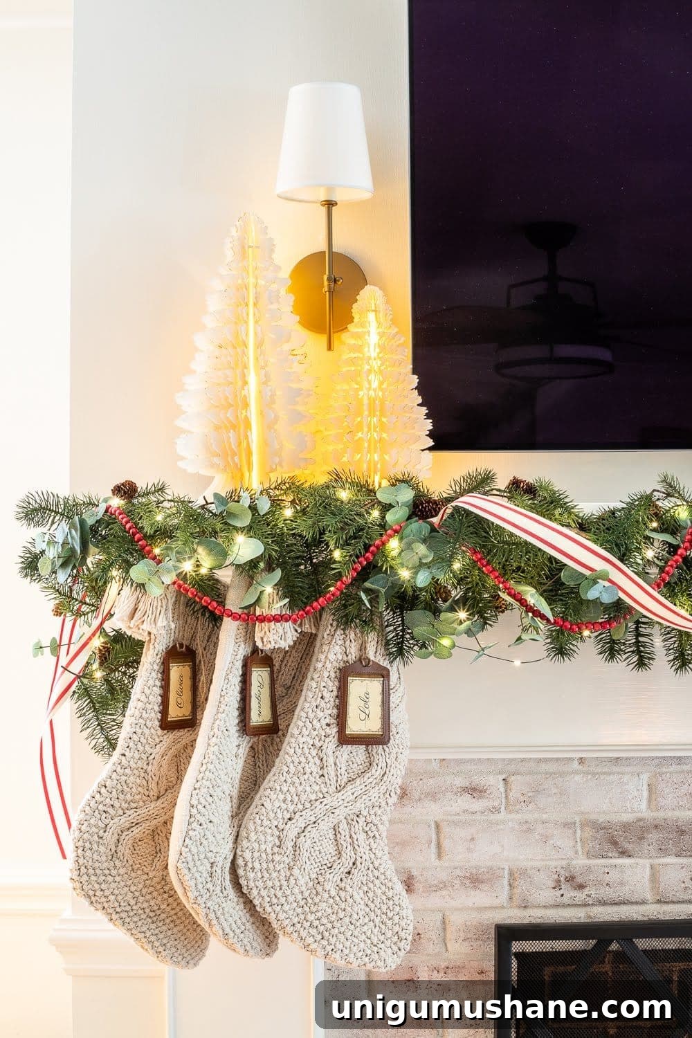 Mix Sentimental Heirlooms with New Decor for a Swedish Christmas 20 Swedish Christmas with paper tree figurines, chunky knit stockings, abundant greenery, fairy lights, and pops of red