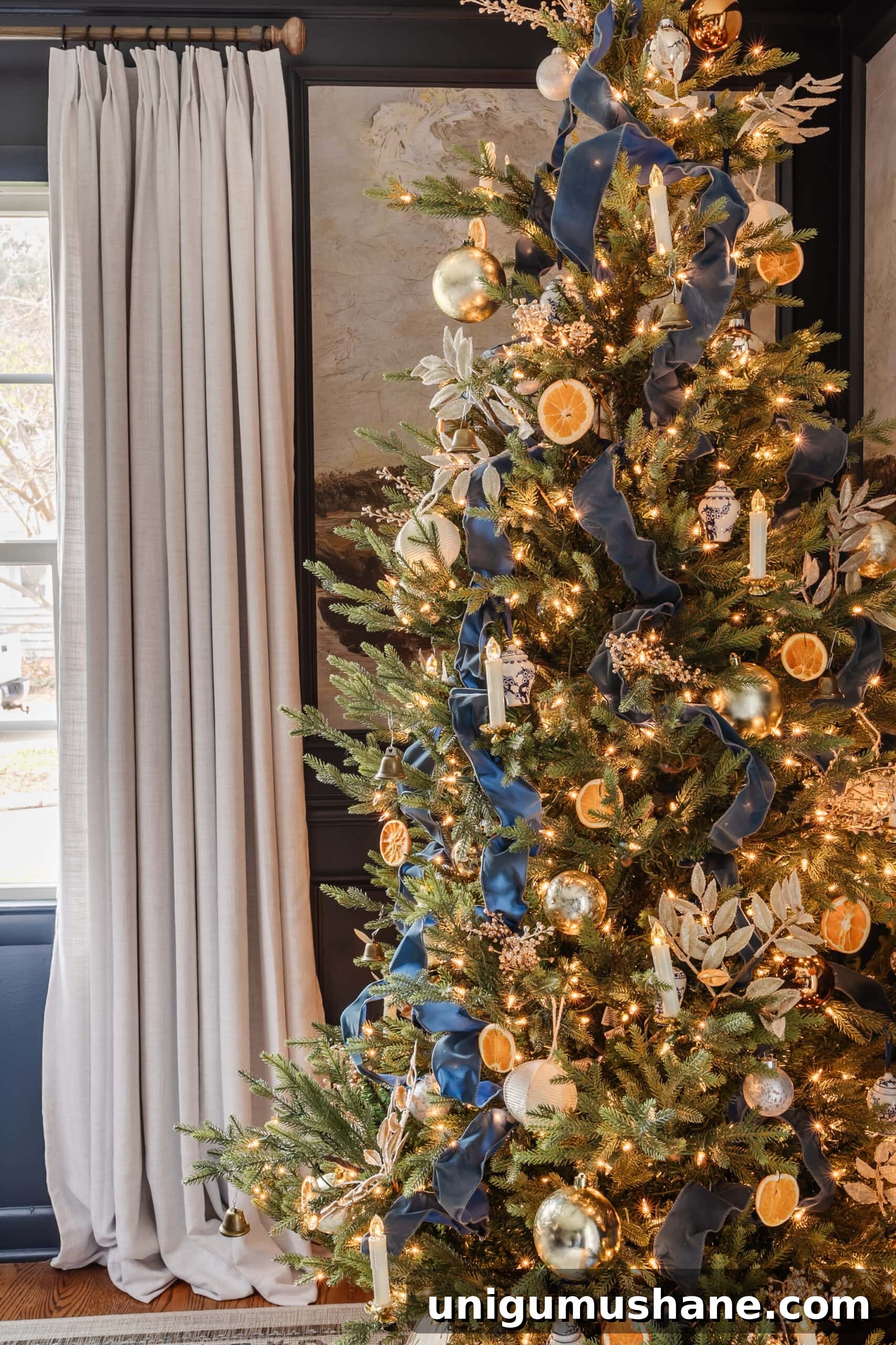 DIY Antique-Style Christmas Tree Candles 12 antique christmas tree candles with blue ribbon and orange slices on a tree