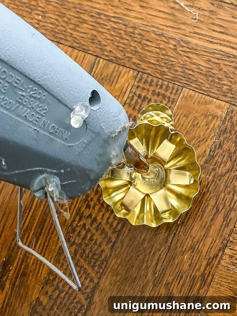 DIY Antique-Style Christmas Tree Candles 6 applying hot glue to candle holder clip