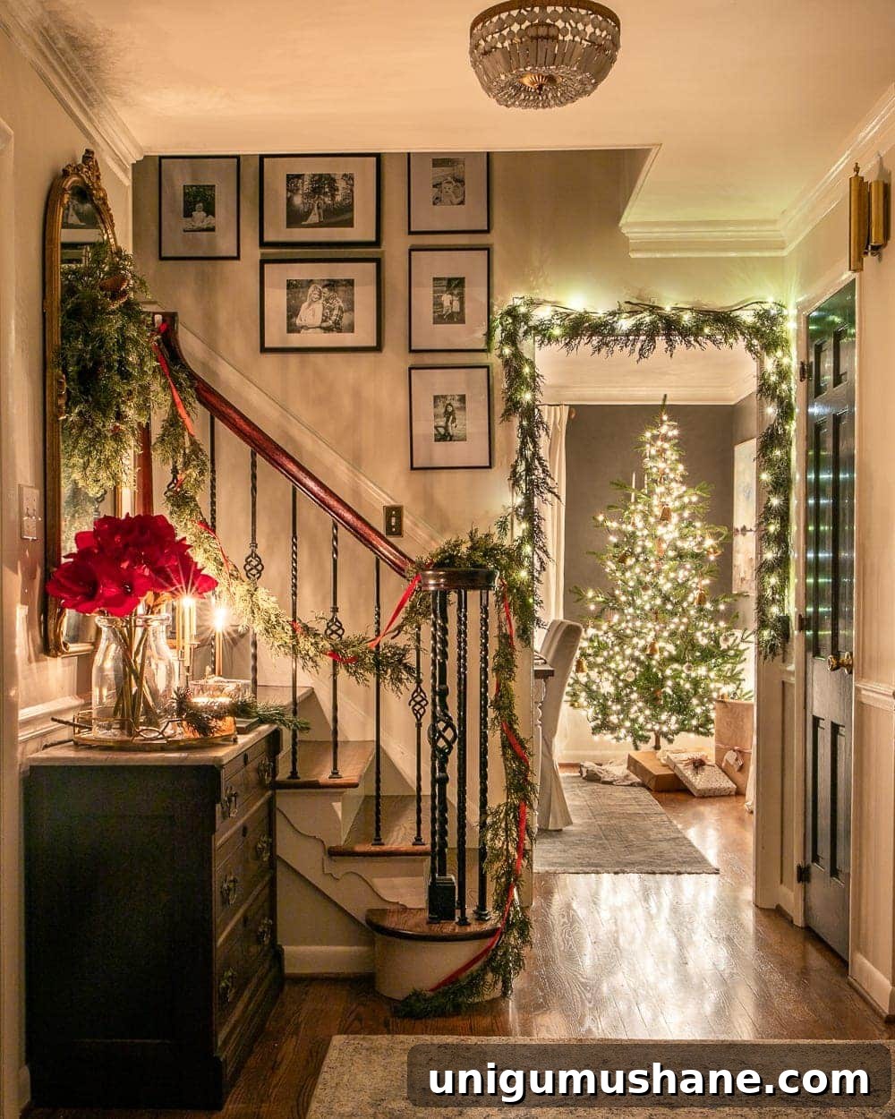 Christmas foyer and dining room at night with twinkle lights and candlelight