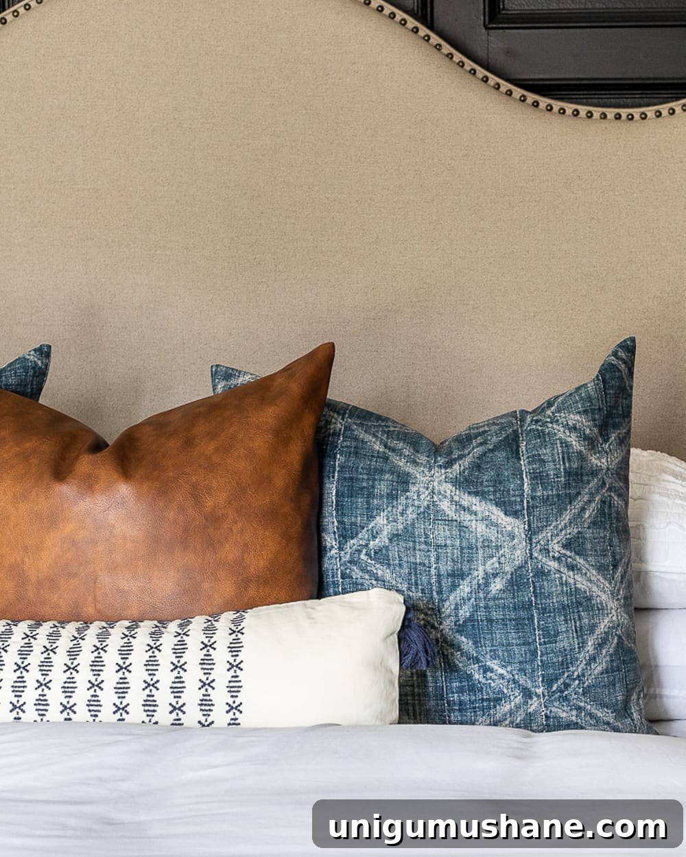 7 Budget-Friendly Ways to Make Your Bed Fluffy 3 throw pillows on a bed