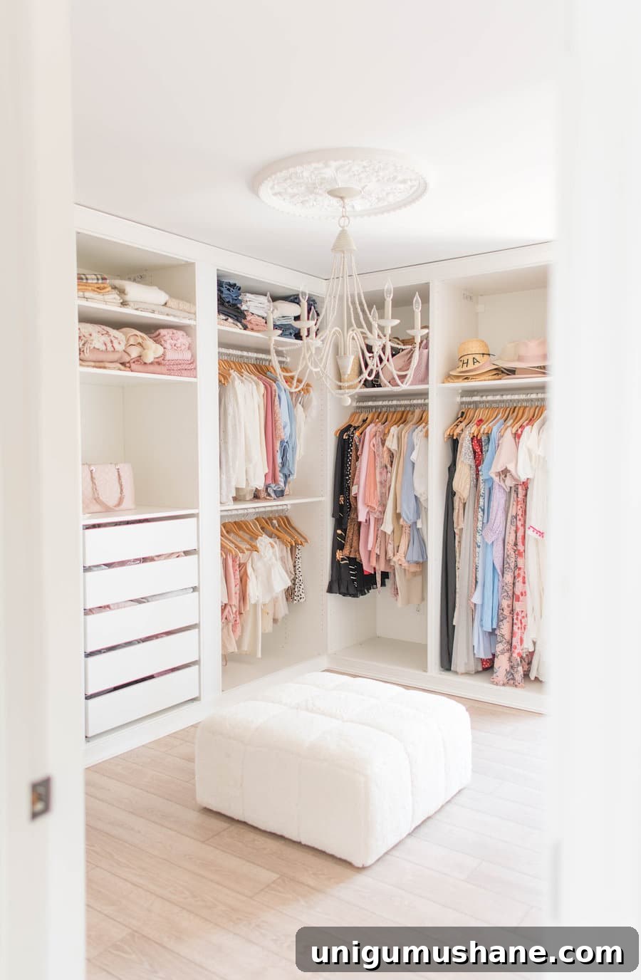 all white built in closet system with ottoman bench