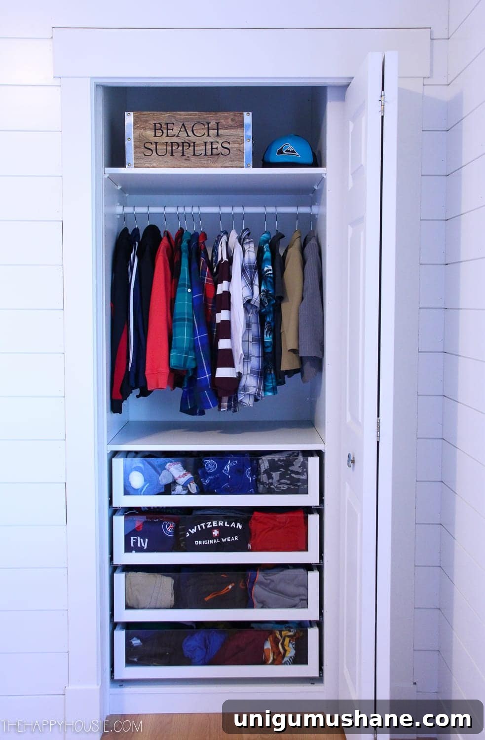 small reach in closet with clear drawer fronts