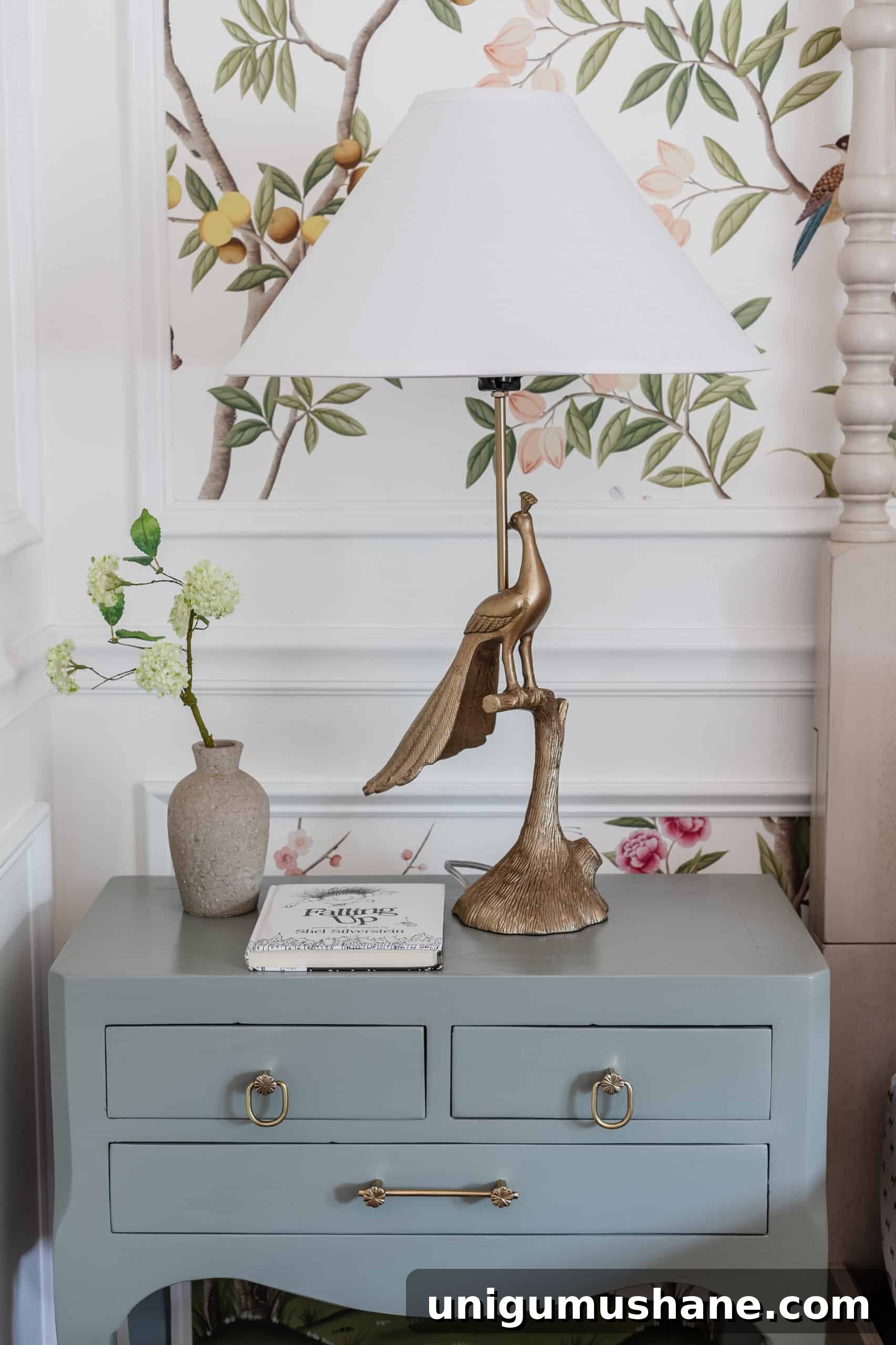 kids bedroom side table with animal lamp, vase of flowers, and book