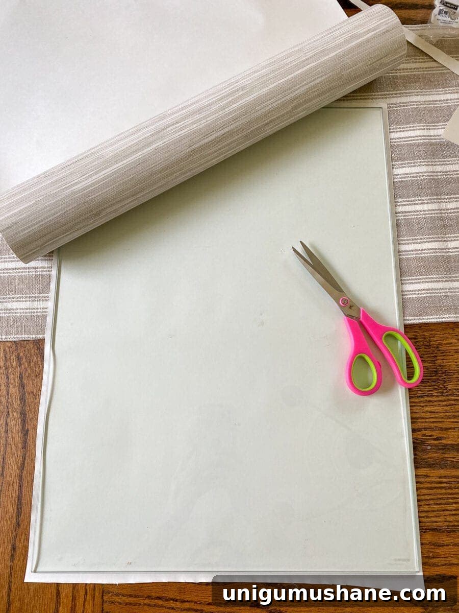 How to Refinish a Footed Grasscloth Buffet 6 Footed Grasscloth Buffet Makeover | Adding removable grasscloth wallpaper to a glass cabinet for concealed storage and added texture