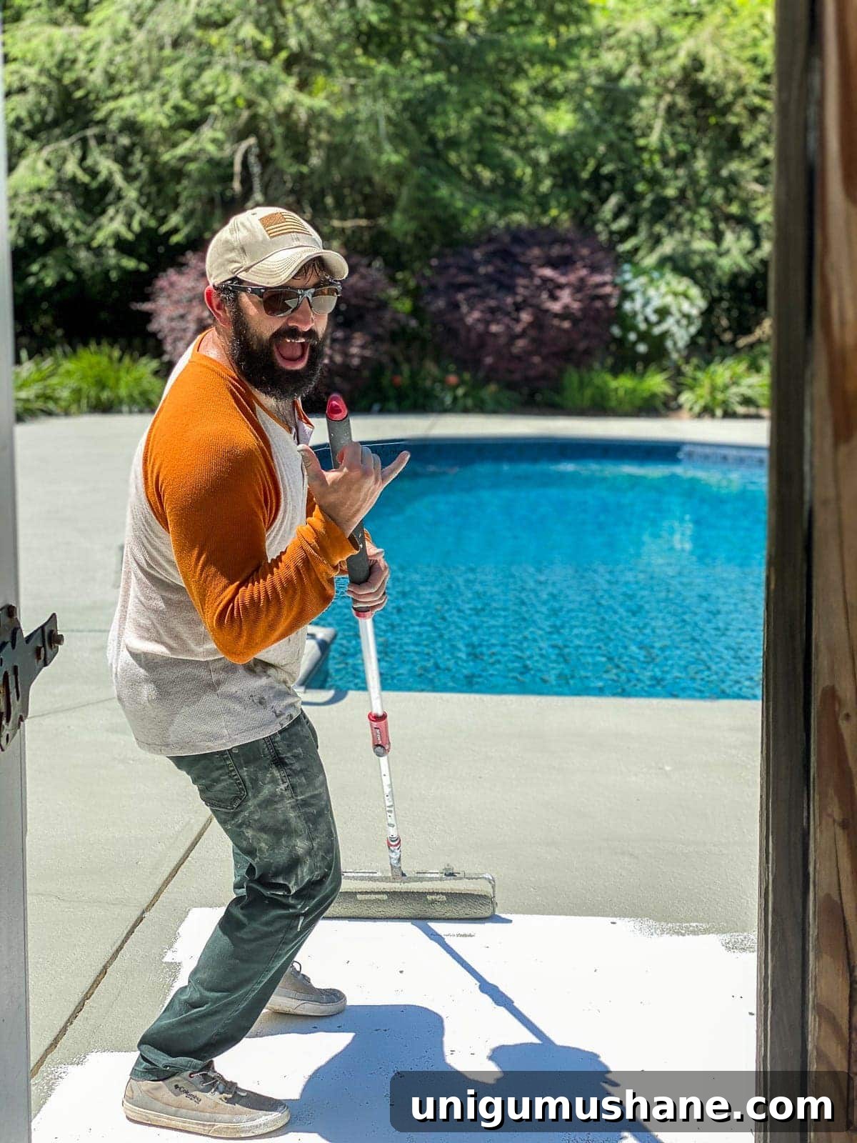 applying concrete paint around a pool deck
