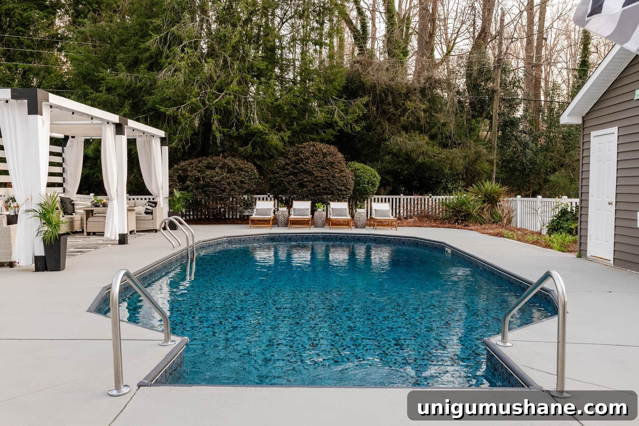 finished painted concrete pool deck and patio with pergola cabana and pool furniture