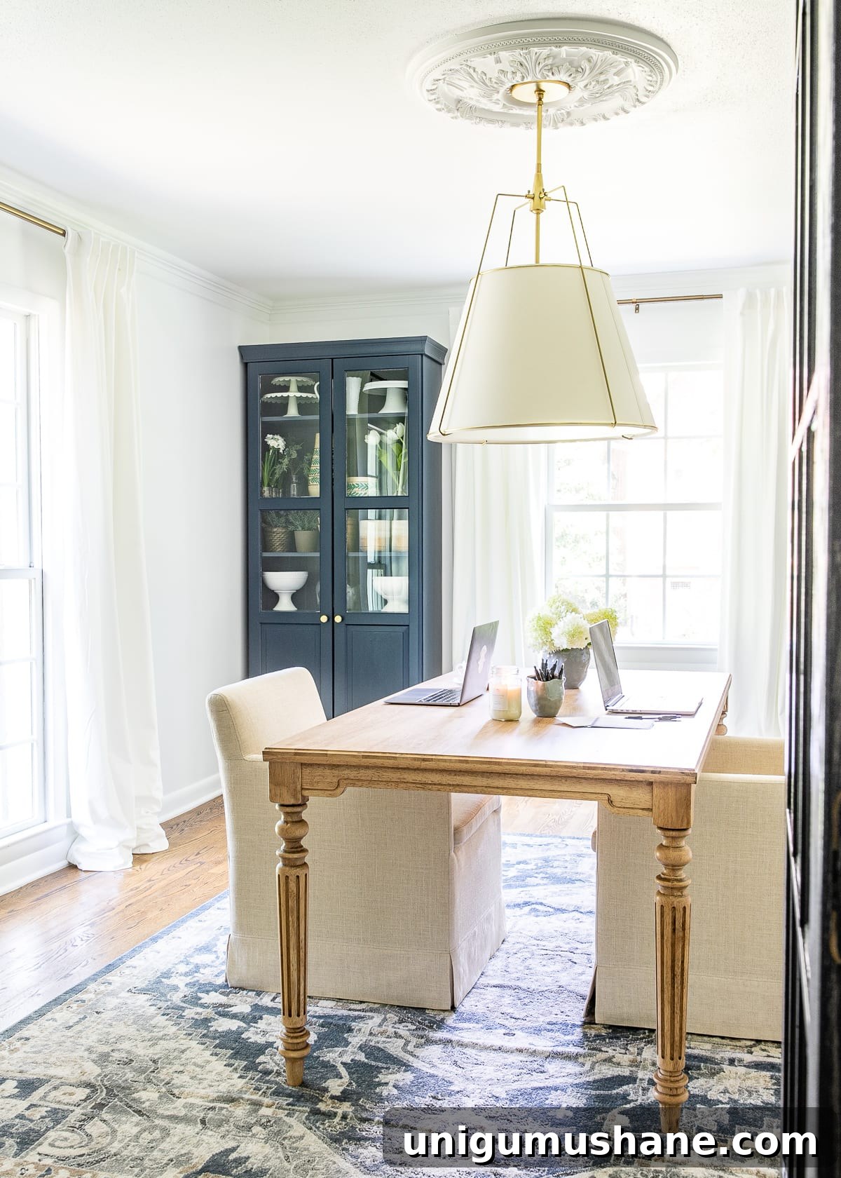 Home Office Makeover Reveal Modern Workspace Before and After 12 white and navy home office with work table and storage cabinets | Benjamin Moore Hale Navy and Chantilly Lace