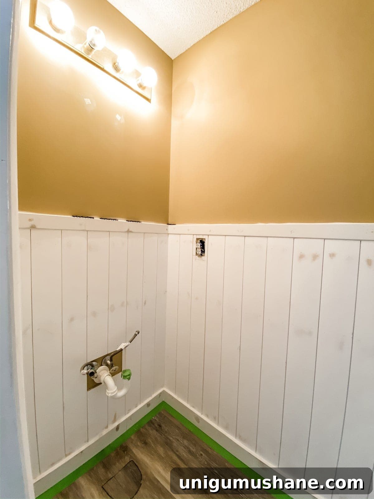 DIY Vertical Shiplap Wainscoting for Bathroom Walls 16 vertical shiplap wainscoting in a bathroom before painting