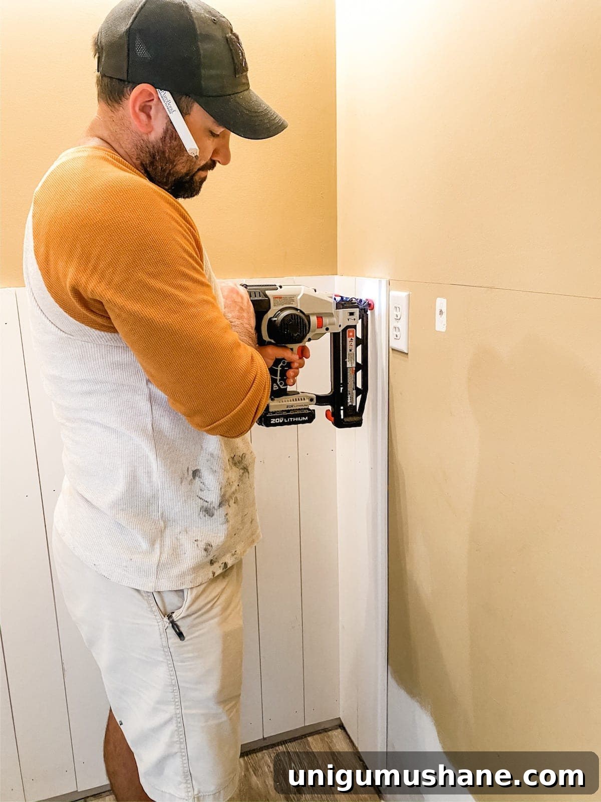 DIY Vertical Shiplap Wainscoting for Bathroom Walls 6 nailing vertical shiplap boards to a wall
