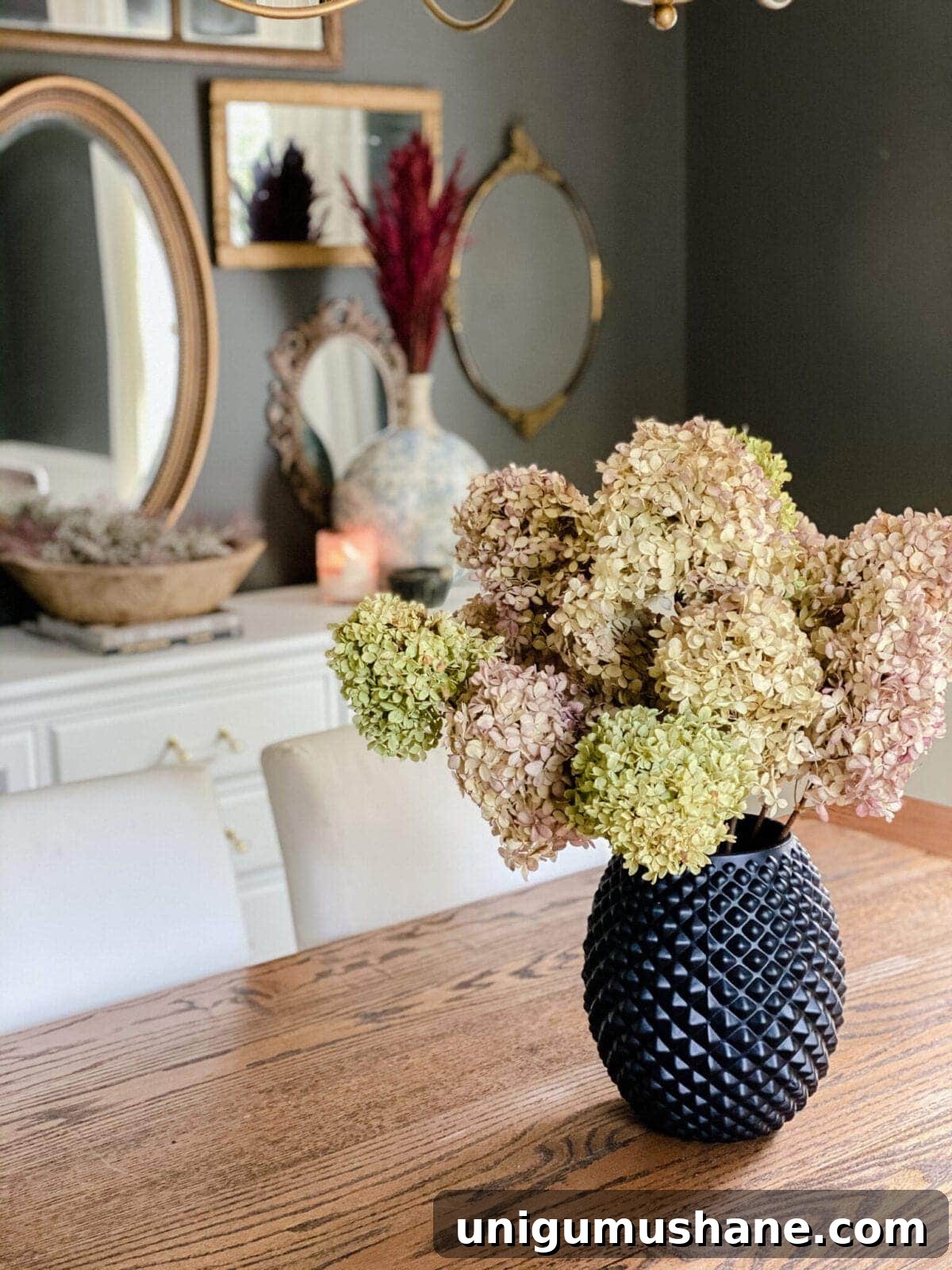 DIY Fall Decor Projects to Make Your Home Cozy 3 dried hydrangeas used as DIY fall decor to create a cozy home in a dining room