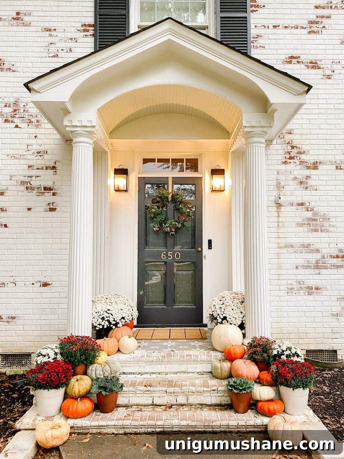 DIY Fall Decor Projects to Make Your Home Cozy 20 cozy front porch decorated with fall decor using pumpkins, mums, and ornamental cabbage