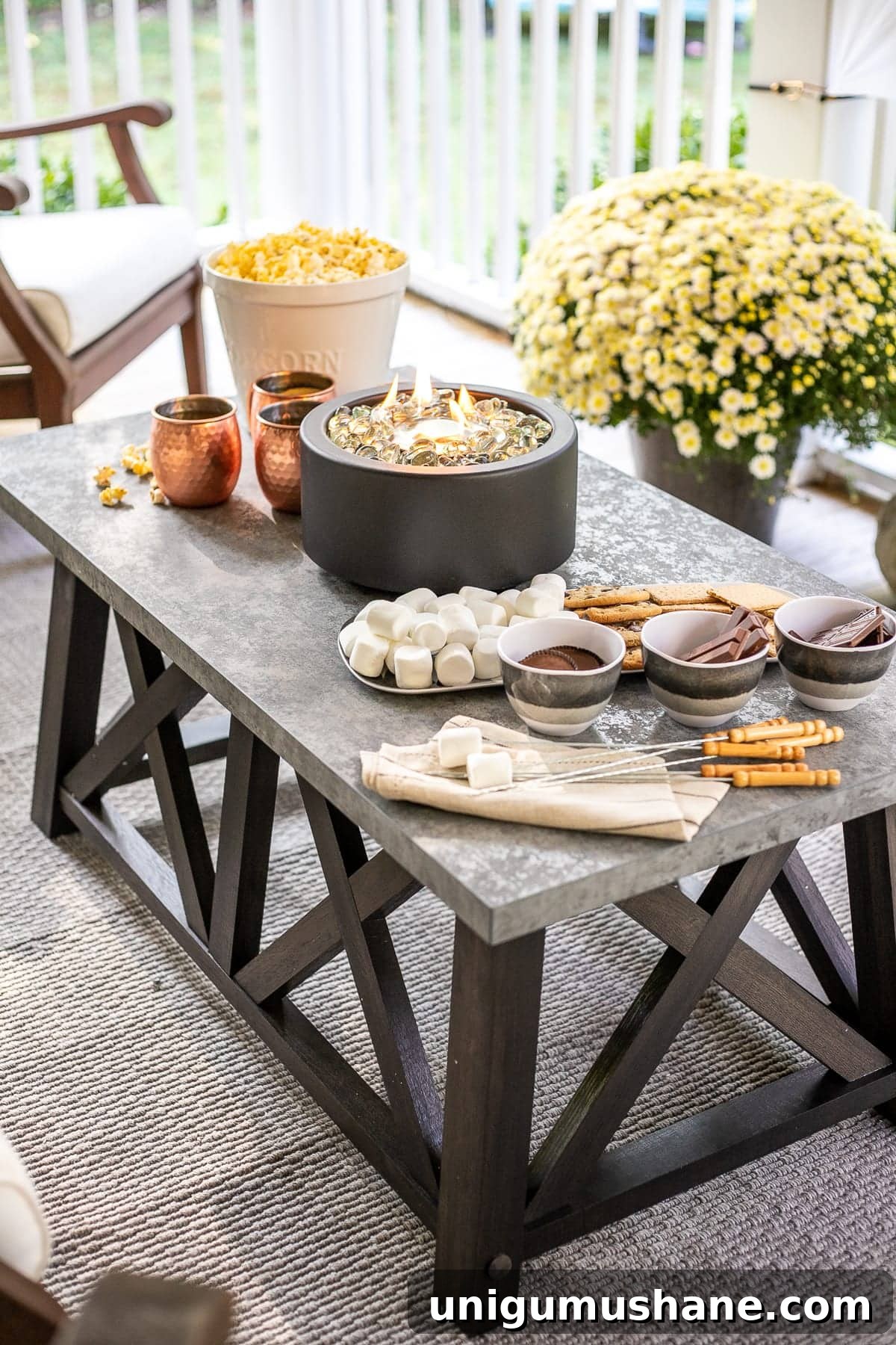 DIY Fall Decor Projects to Make Your Home Cozy 21 DIY s'mores table featuring a tabletop fire pit and s'mores ingredients