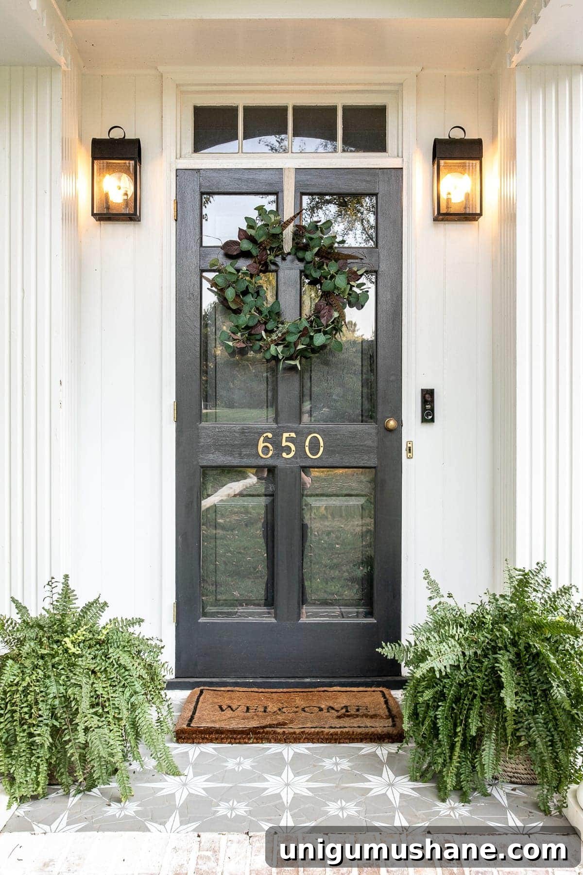 Front porch decorated for early fall with DIY wreath and stenciled floor