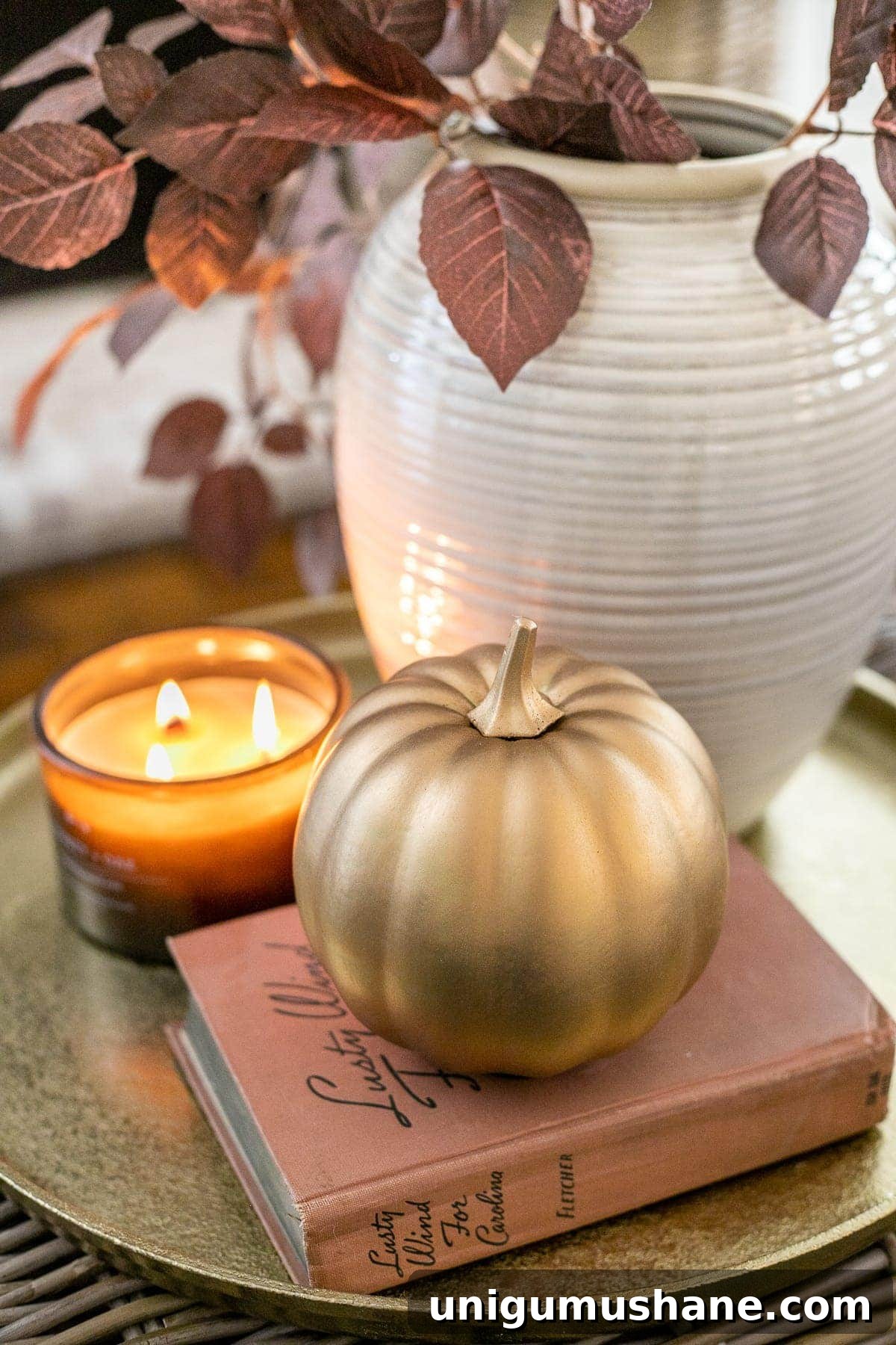14 Fall Decor Finds to Shop at Thrift Stores 13 fall decor on a tray with vase of leaves, candle, and pumpkin