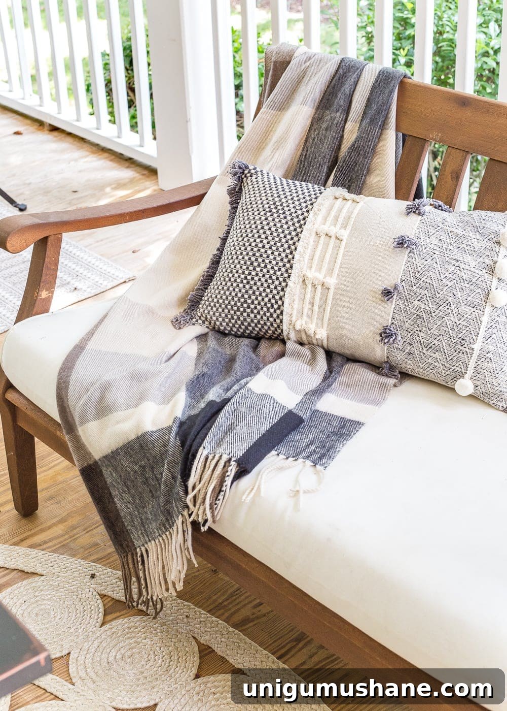 14 Fall Decor Finds to Shop at Thrift Stores 9 plaid throw blanket and pillow on outdoor bench