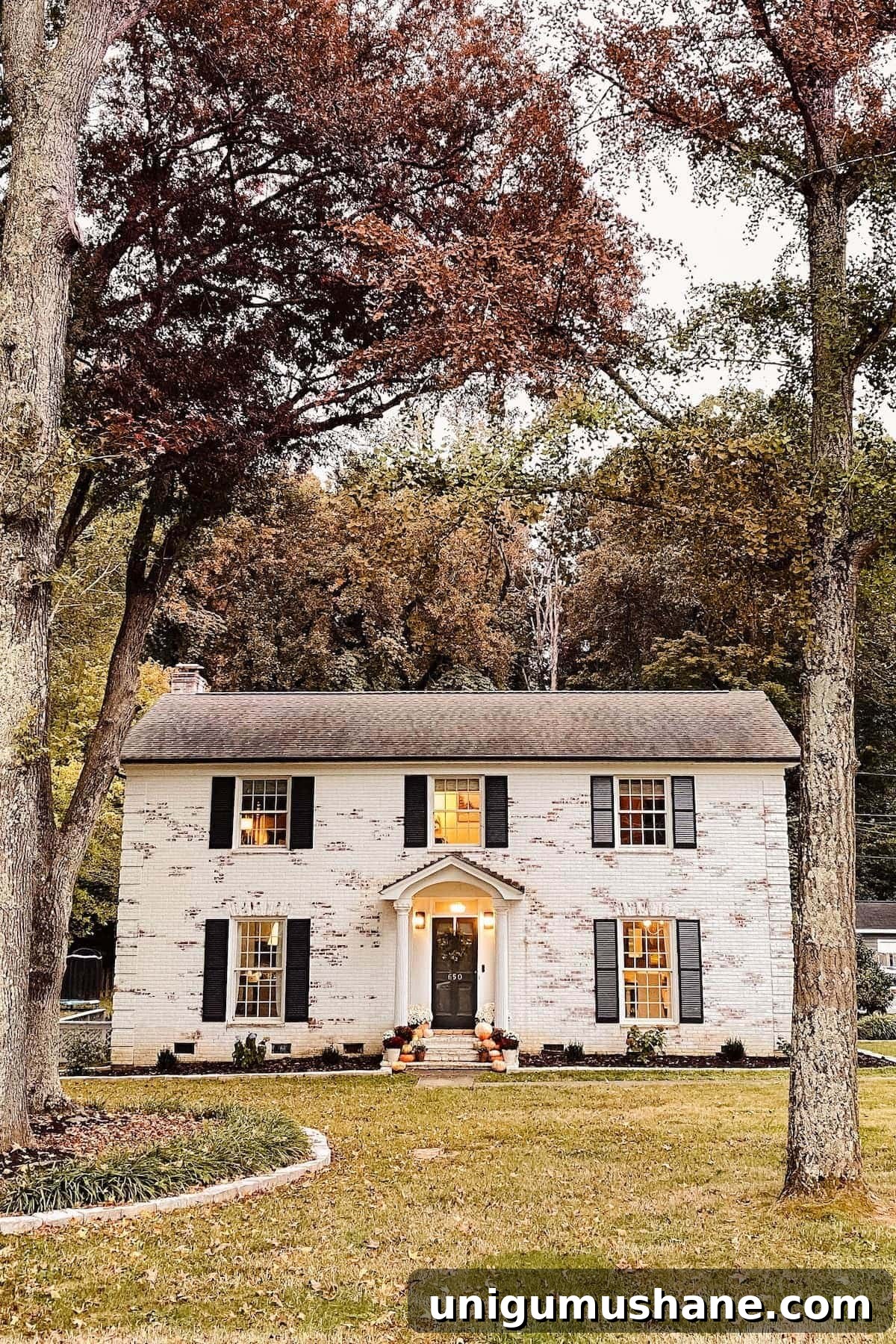 Colorful Fall Porch Stoop Decor for a Cozy Entryway 5 limewashed brick colonial house decorated for fall with pumpkins and mums