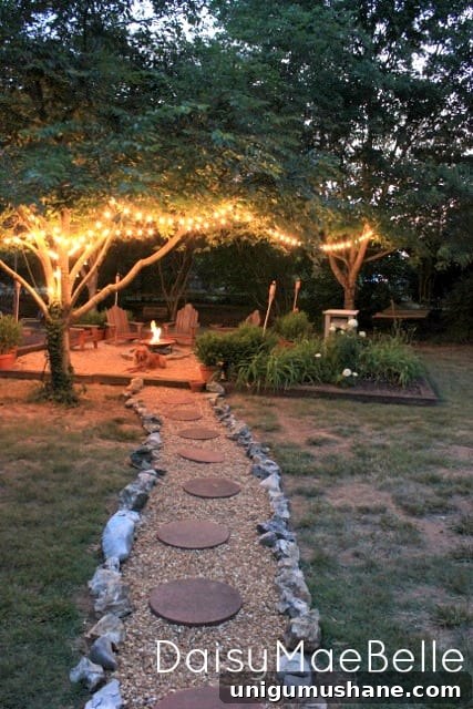 fire pit with string lights in trees