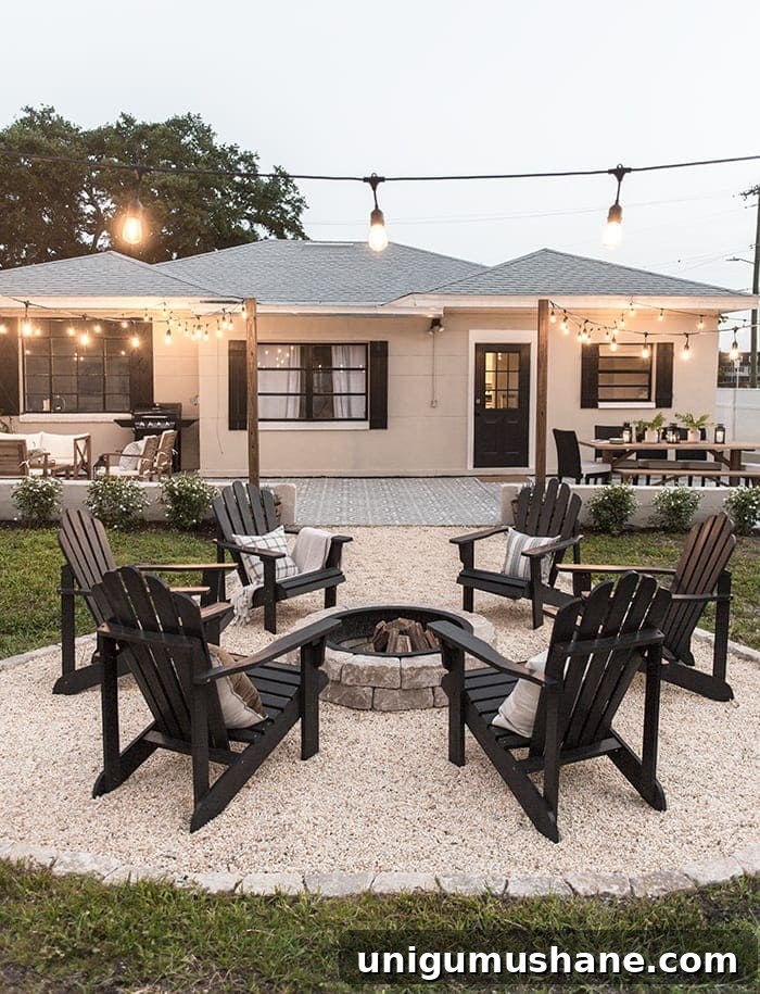backyard fire pit with string lights and pea gravel
