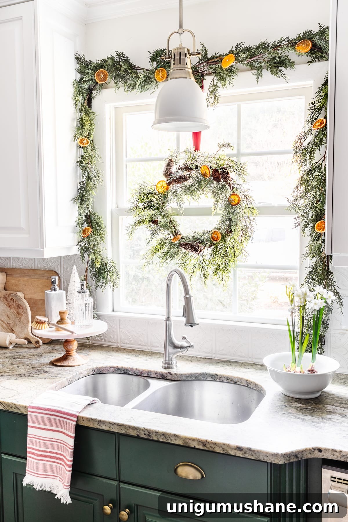 DIY Christmas Brunch Decor Ideas with Printable Art 12 bowl of paperwhite flowers beside a kitchen sink with garland and Christmas wreath on a window