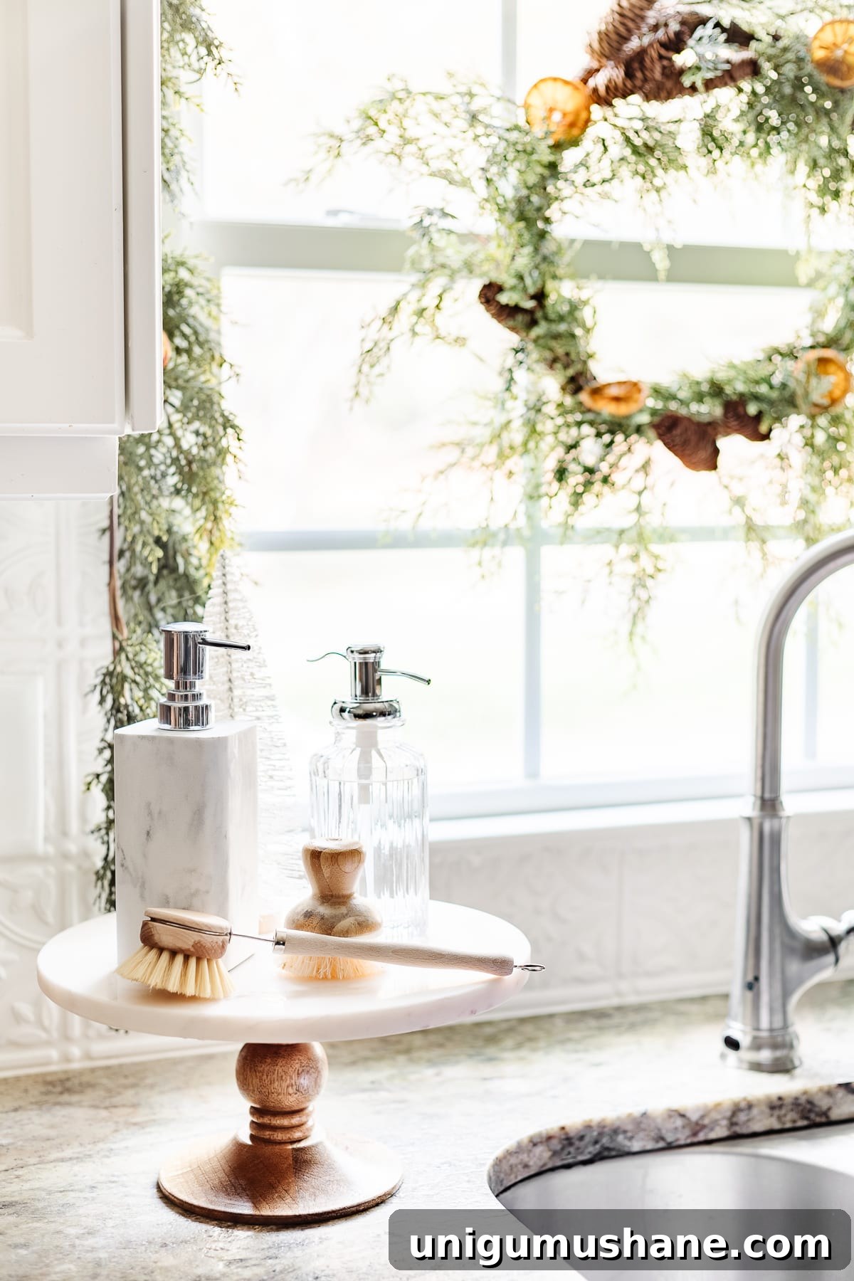 DIY Christmas Brunch Decor Ideas with Printable Art 13 cake stand next to kitchen sink with soaps and bottle brush tree