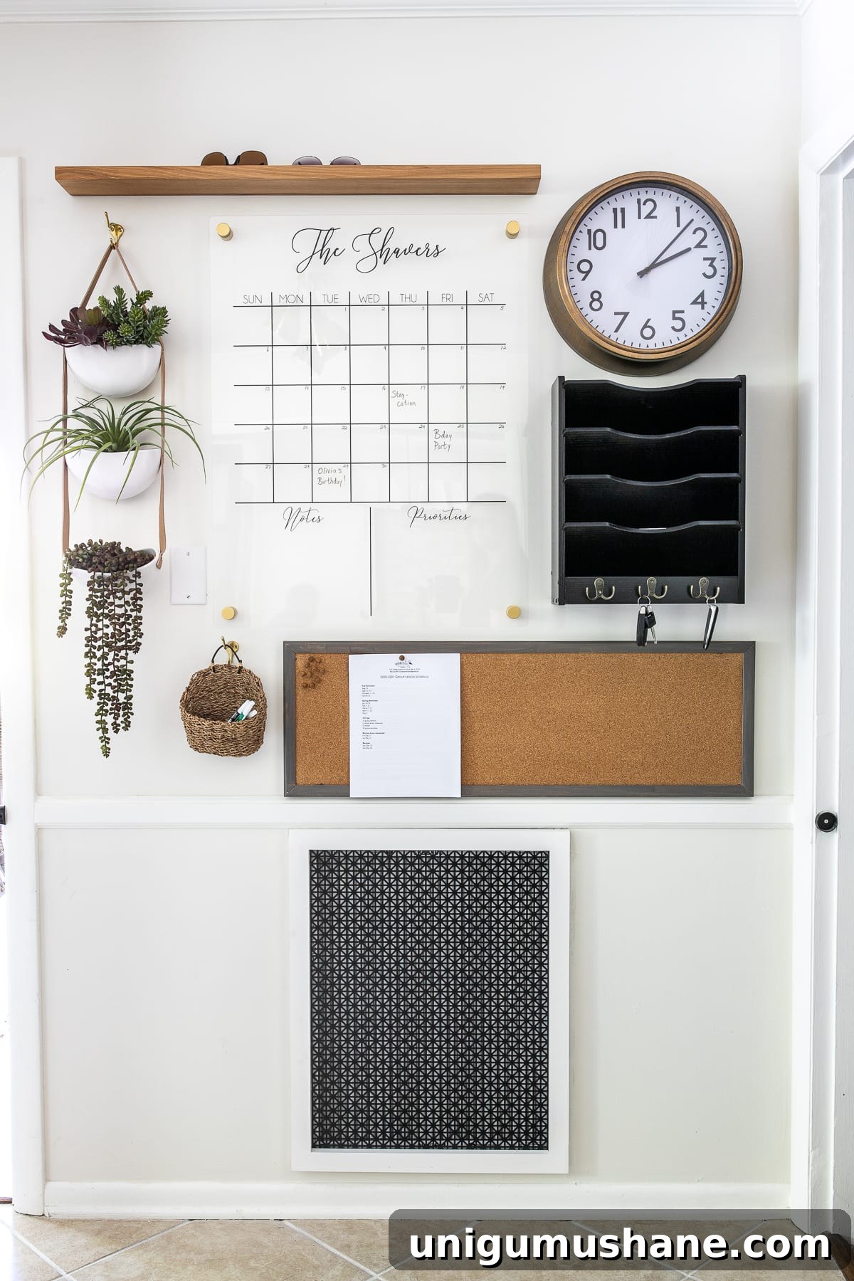 Home Organization Essentials for a Tidy Space 3 Command center wall with calendar, mail sorter, memo board, and drop zone to keep an entryway clear of clutter.