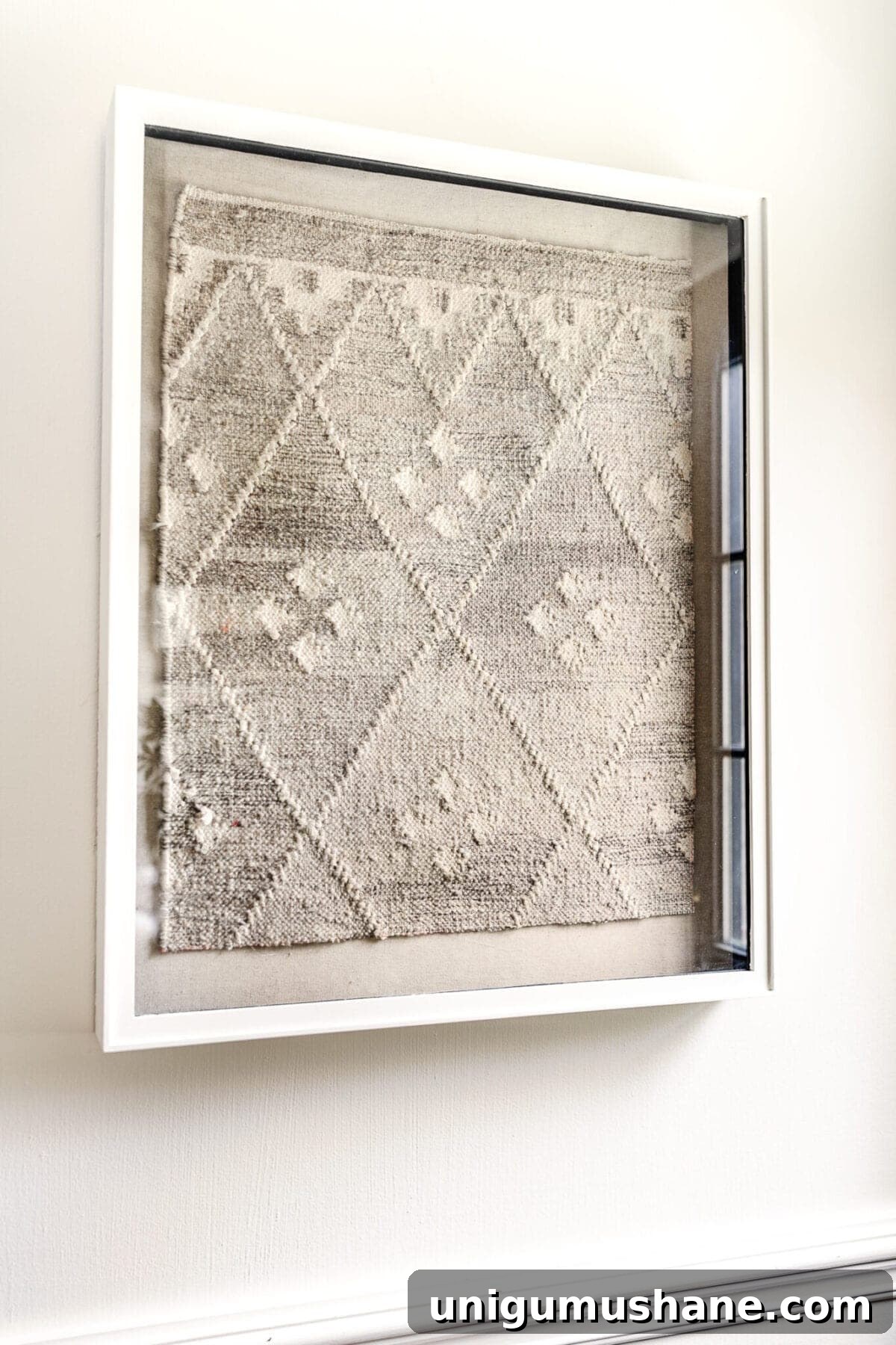 DIY designer-inspired textile wall art made from an old rug in a shadow box
