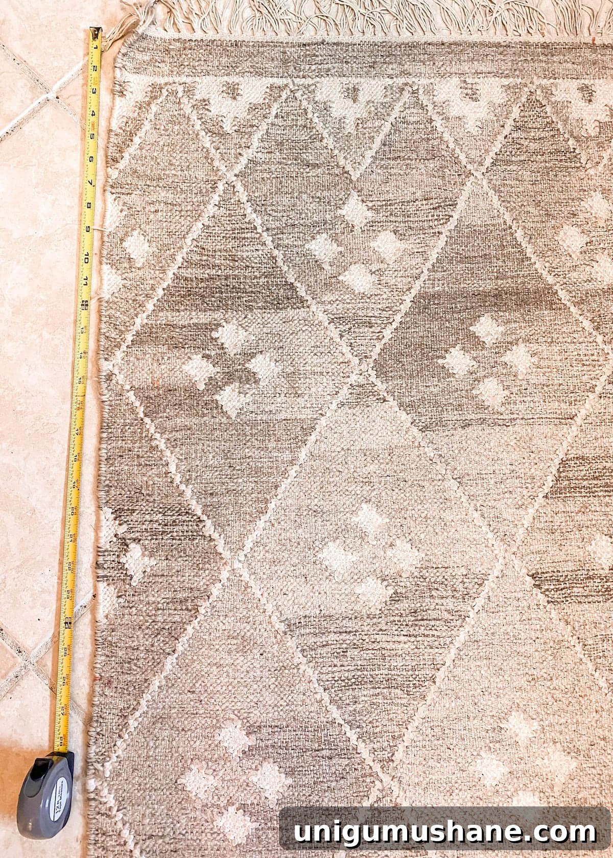 Marking the rug before cutting a piece for DIY textile wall decor