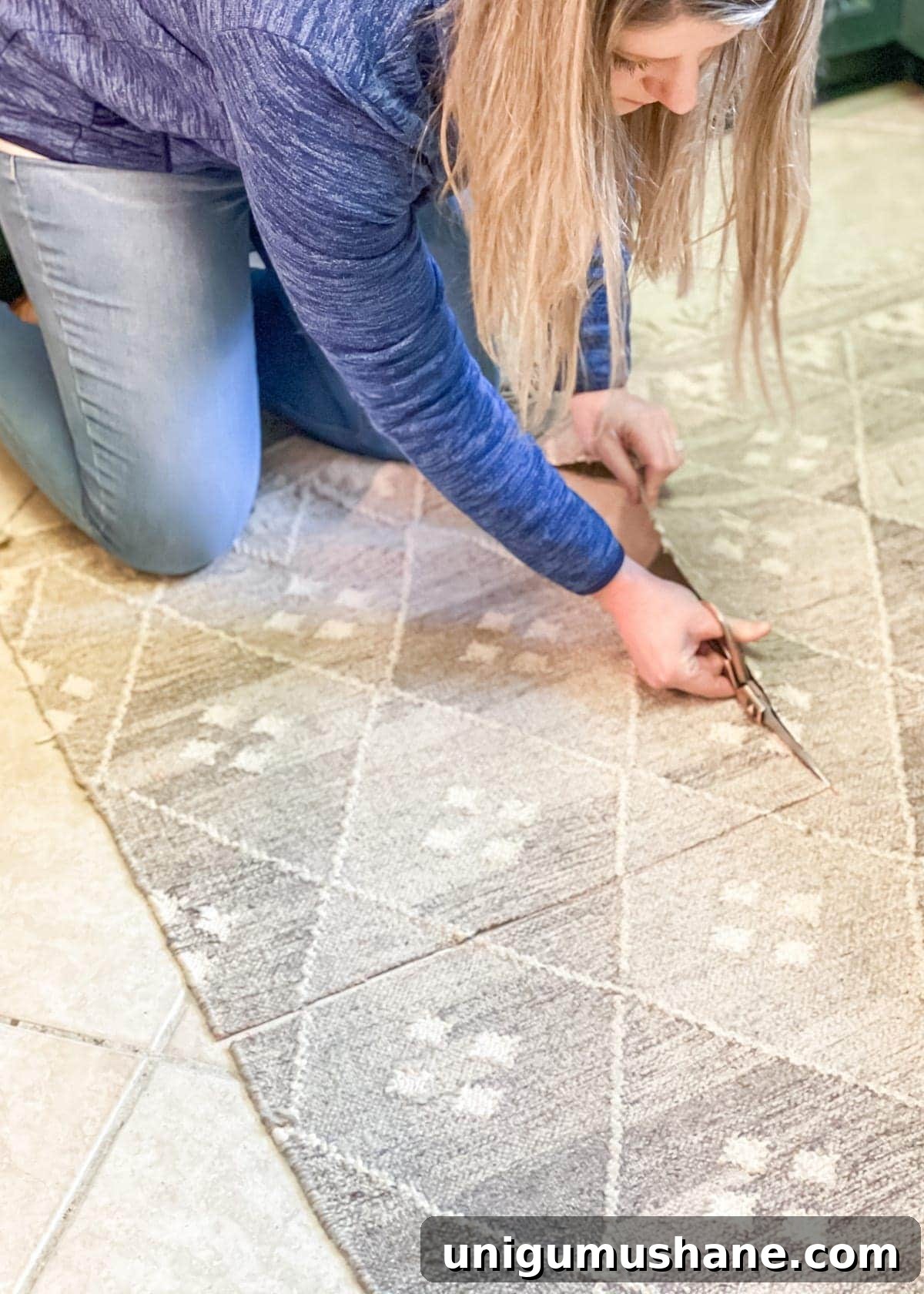 Cutting a flatweave rug with fabric scissors for framed textile art
