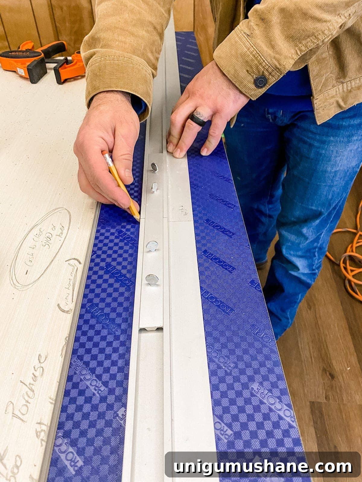 Using a straight edge to cut luxury vinyl plank flooring