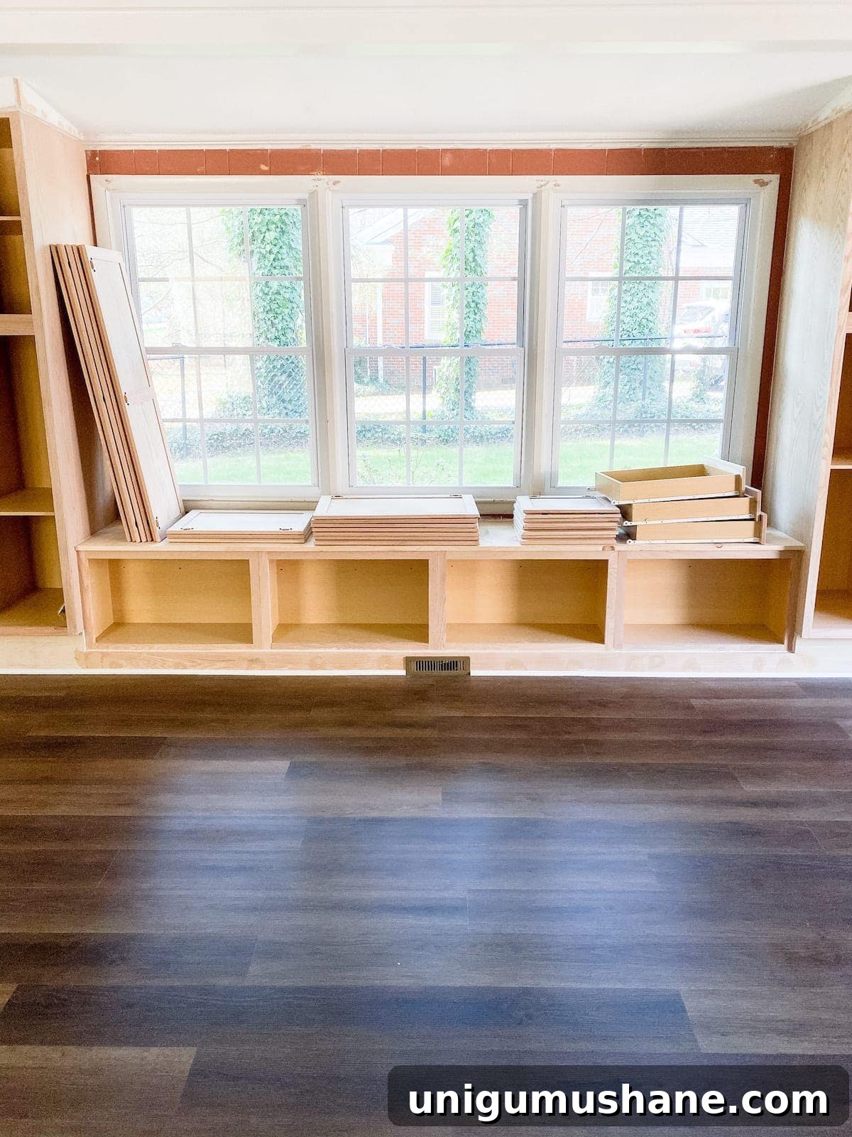 luxury vinyl plank flooring with DIY built-in cabinets and window seat