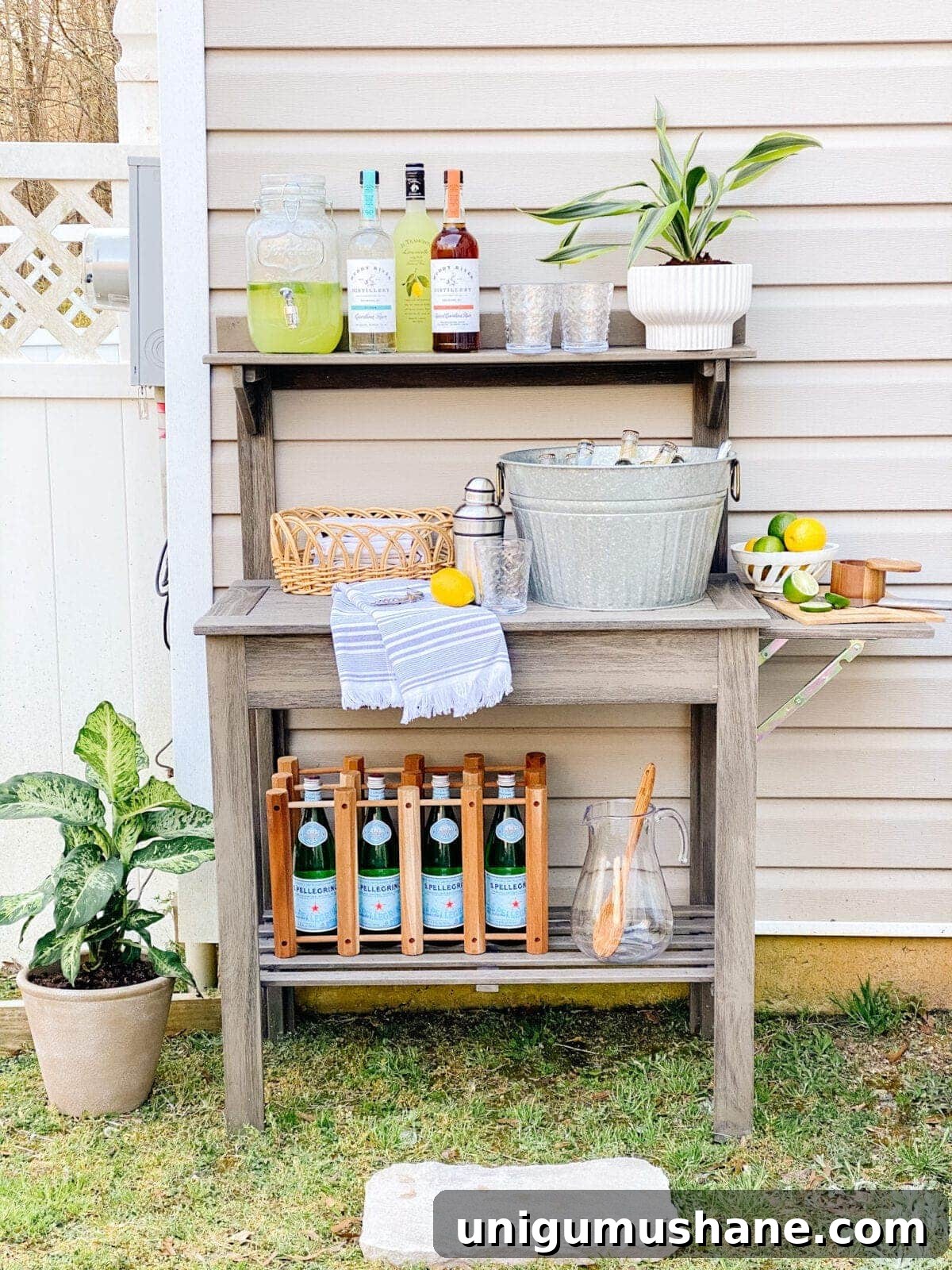 DIY Patio Ideas on a Budget to Transform Your Outdoor Space 7 potting bench used as an outdoor bar with thrifted containers for backyard entertaining