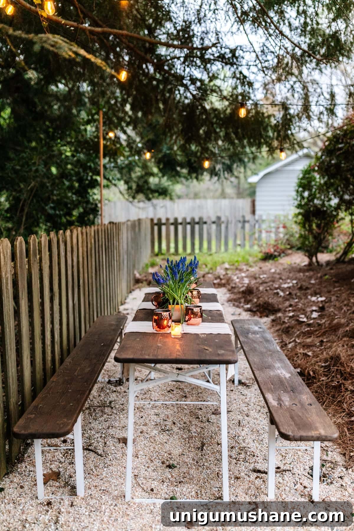 DIY Beer Garden: Transform Your Neglected Backyard 4 Hanging string lights on wooden dowels for a DIY backyard dining area