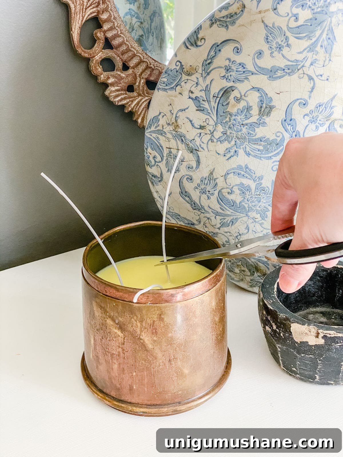 How to Make a Candle from a Thrifted Brass Canister 6 cutting wicks on a DIY candle made from an antique brass canister