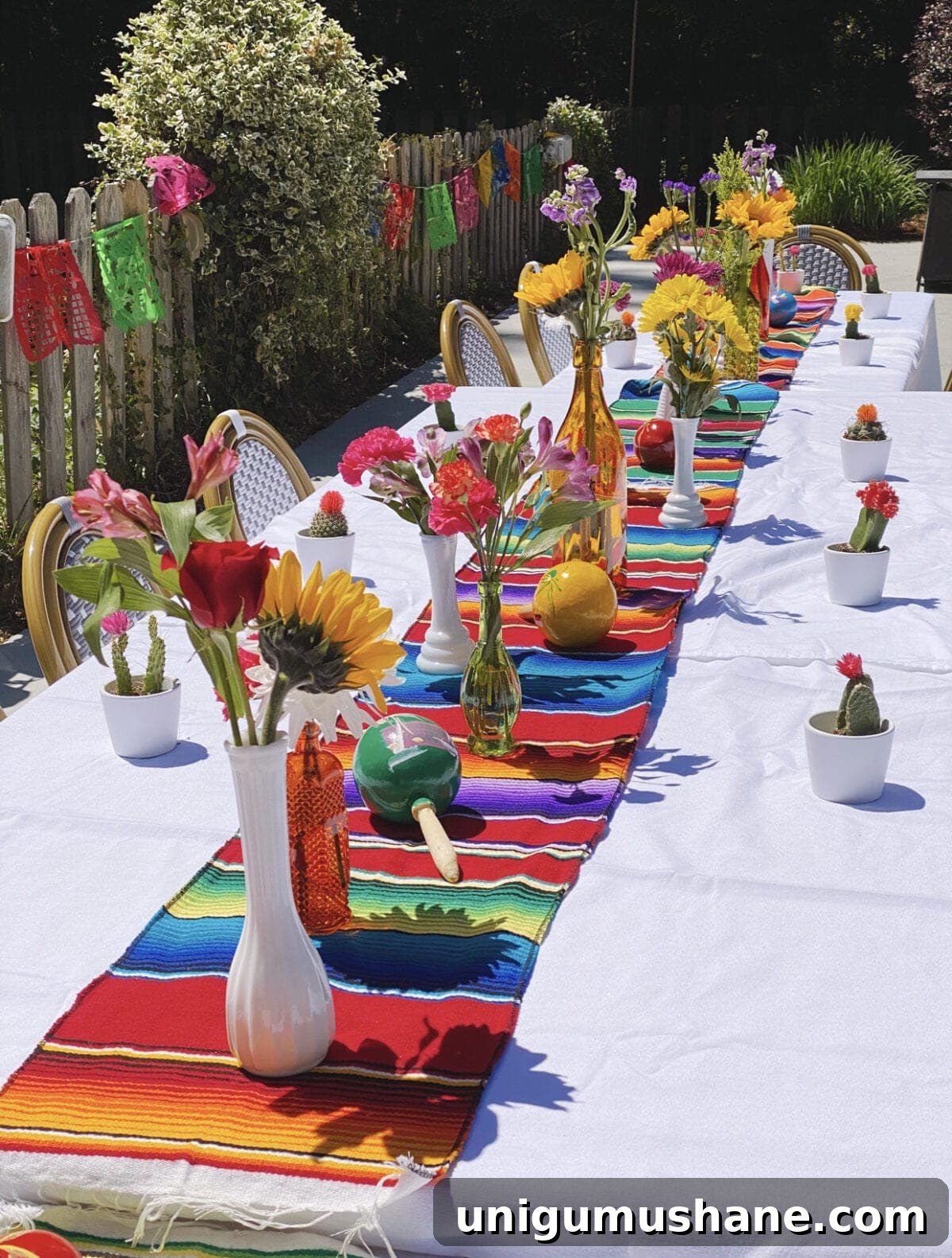 How to Plan a Fiesta Baby Shower: Themes, Decor and Menu Ideas 4 Serape table runner with Mexican flowers, maracas, and baby cacti party favors