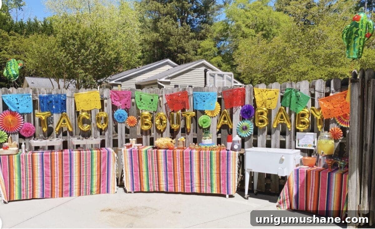 How to Plan a Fiesta Baby Shower: Themes, Decor and Menu Ideas 8 baby shower taco bar decorated with Mexican serape tablecloths and balloons
