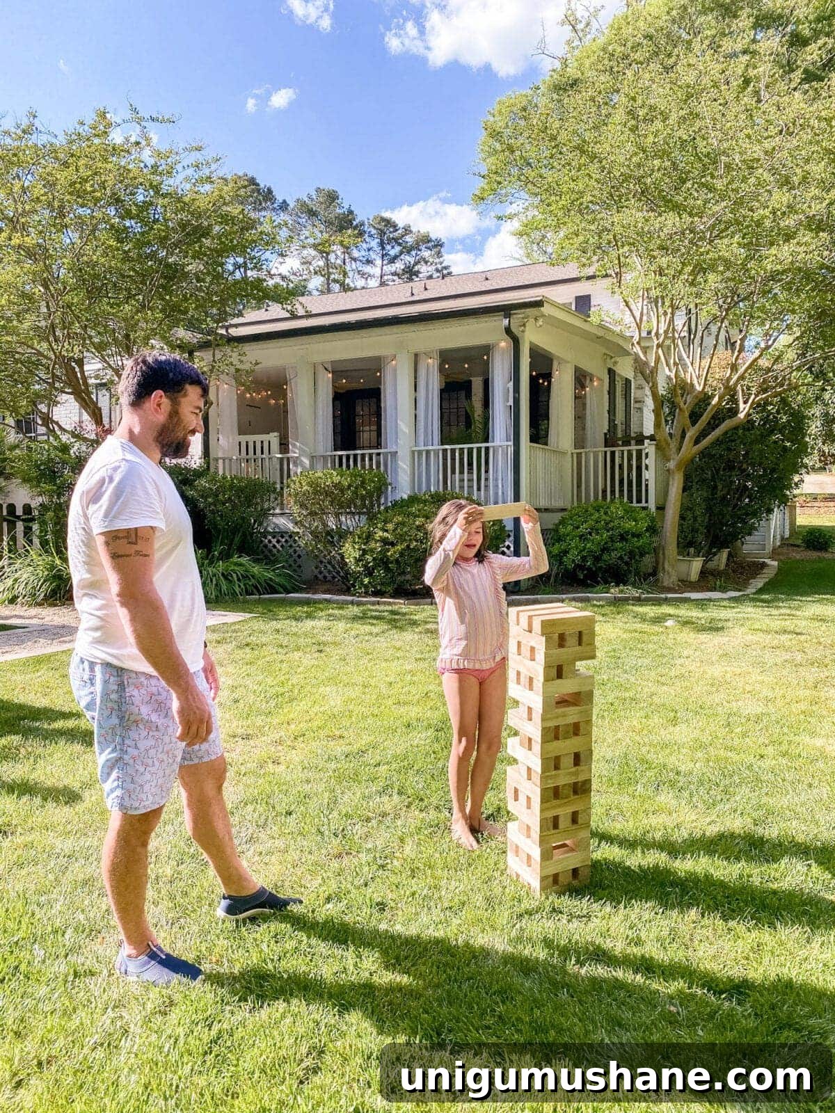 Yard Games to Make Your Backyard Barbecue Unforgettable 6 father and daughter playing backyard Giant Jenga yard game