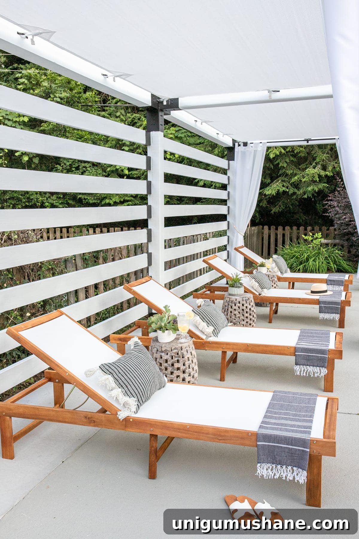 pool lounge chairs under a white DIY pergola