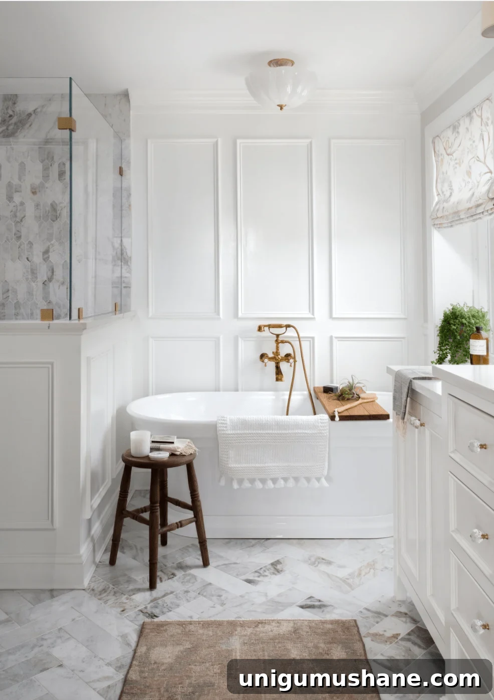 picture frame molding in a bathroom with soaking tub and herringbone tile