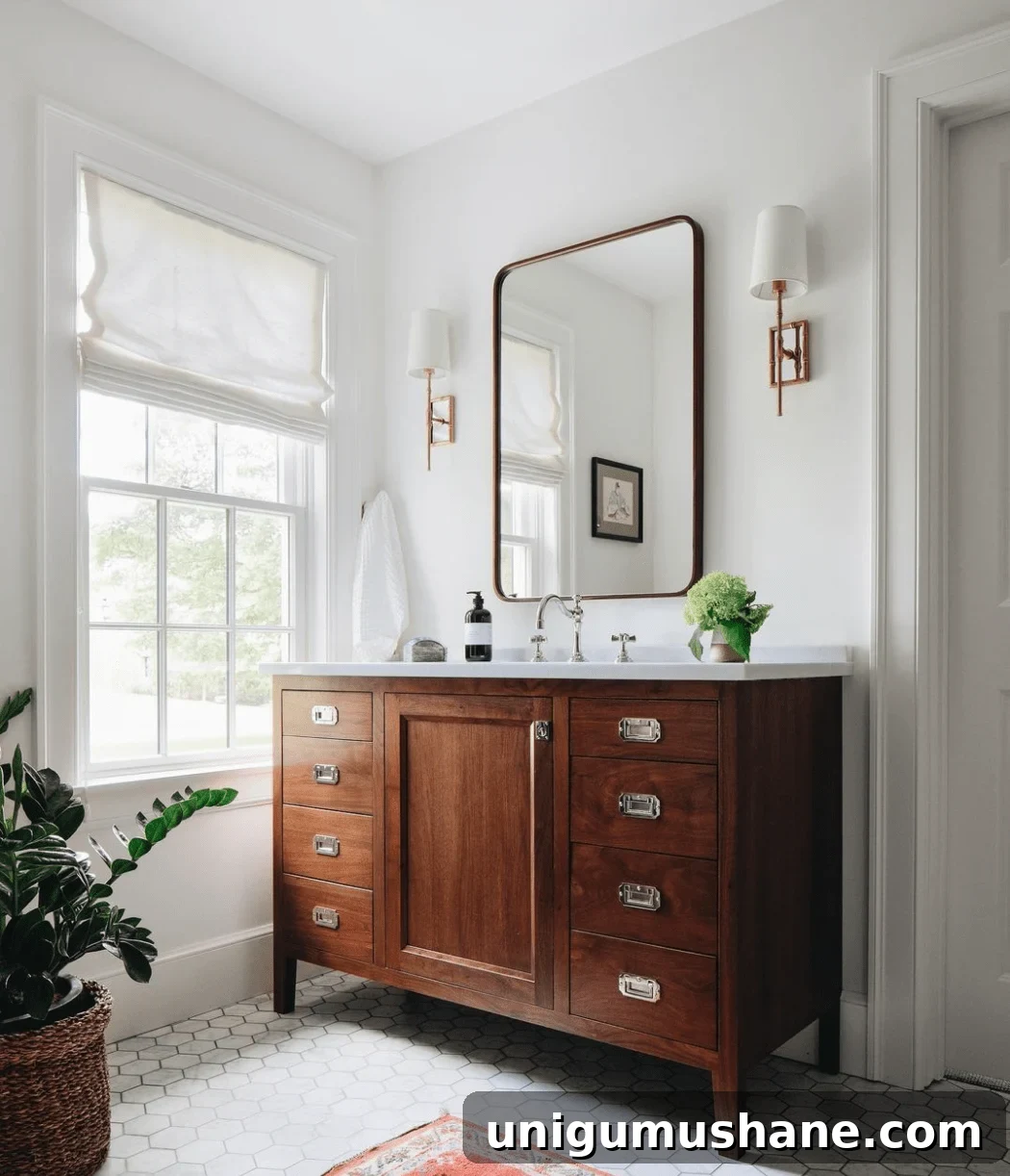 medium toned wood bathroom vanity with hexagon tile and shaded sconces